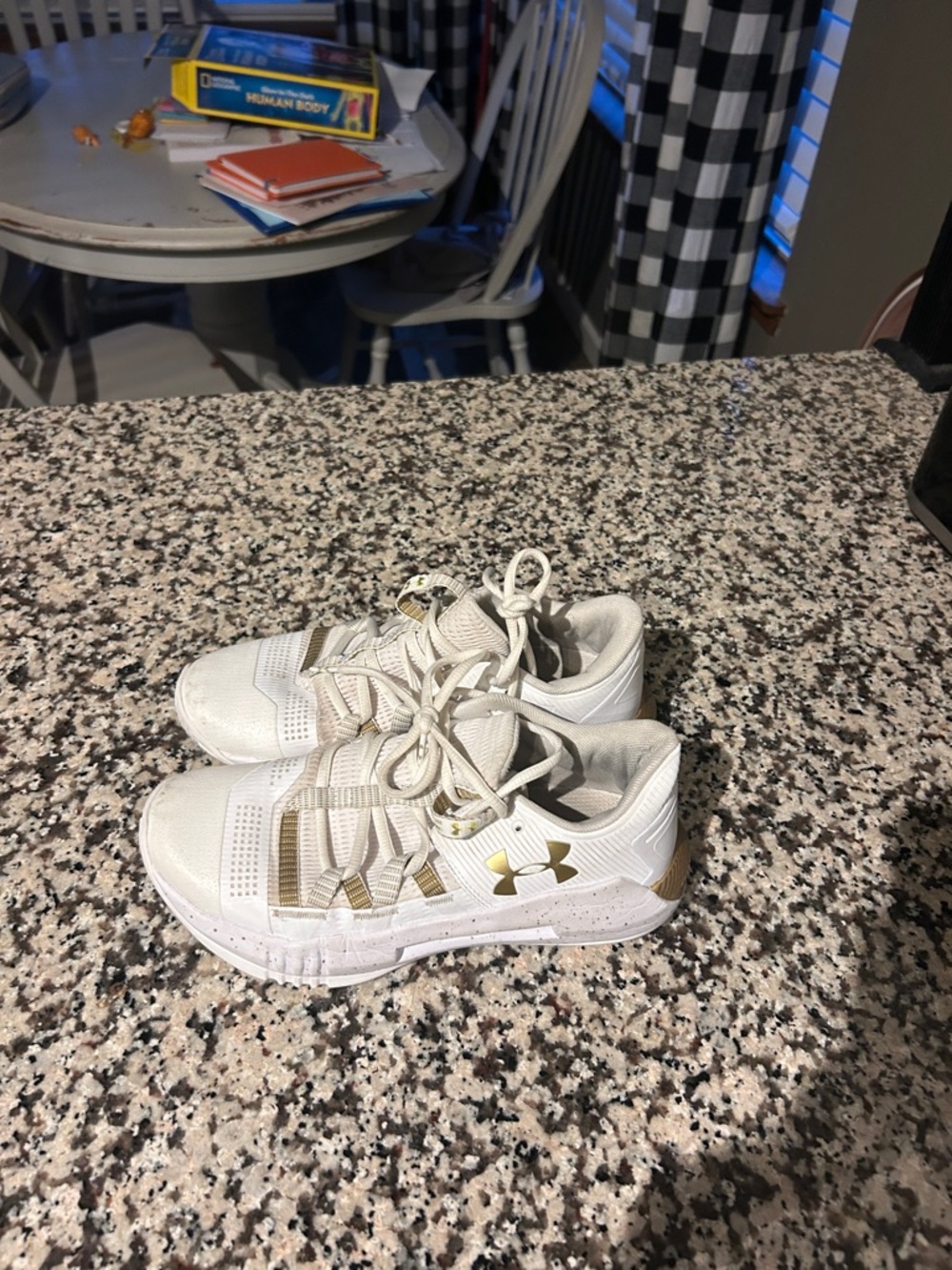 Under Armor women’s White volleyball shoes with Gold Accents